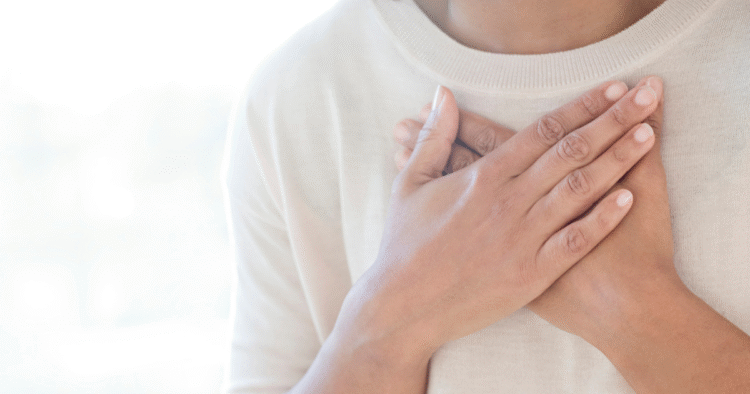 A person covering their heart with their hands
